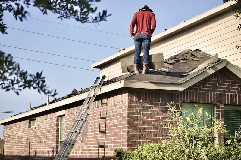 Professional roofer working on a residential roof in Harford Commons